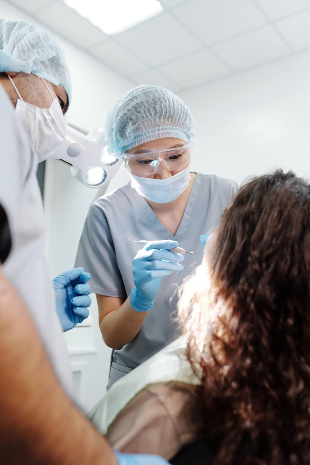 Dentist performing dental procedure on patient